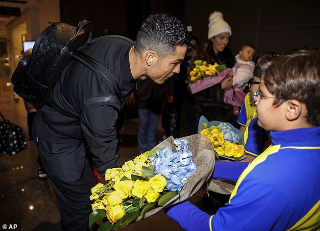 Cristiano Ronaldo was handed some flowers by young fans as he arrived in Riyadh on Monday