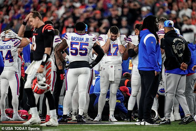 Buffalo Bills gather as an ambulance parks on the field while CPR is administered to Buffalo Bills safety Damar Hamlin (3) after a play in the first quarter of the NFL Week 17 game between the Cincinnati Bengals and the Buffalo Bills at Paycor Stadium in downtown Cincinnati.  The game was suspended with a suspension in the first quarter after Buffalo Bills safety Damar Hamlin (3) was taken away in an ambulance following a play.