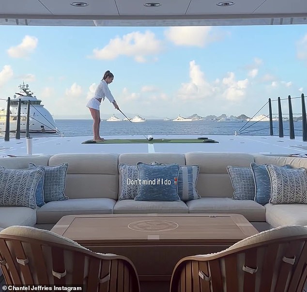 Swing: The amateur athlete took the opportunity to practice her golf swing on the putting green at the stern of the boat, writing 'I don't care if I do it'