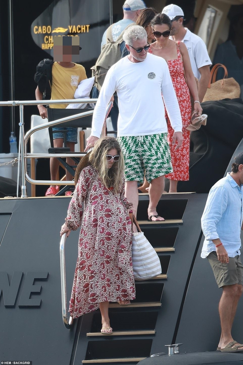 Casual cool: Gayheart rocked a billowy red dress while the Grey's Anatomy actor wore a white shirt and green shorts