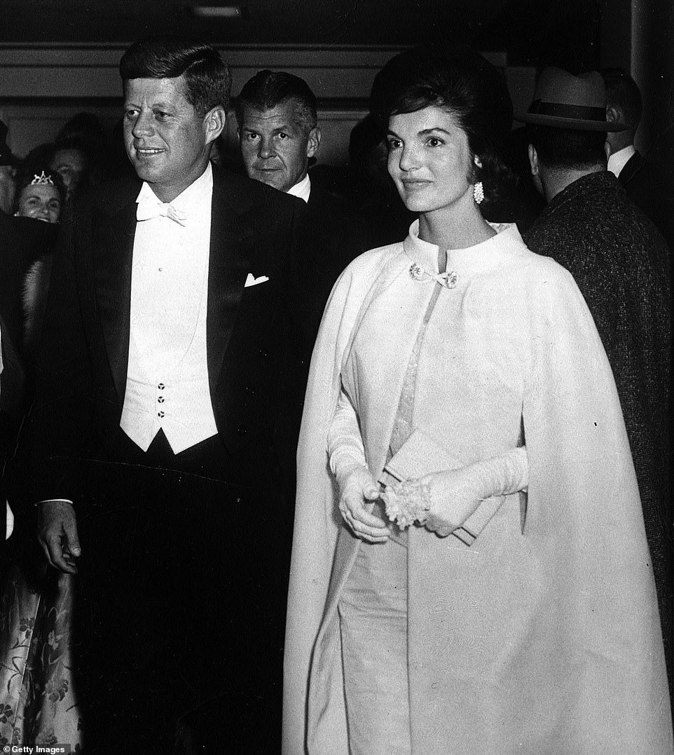 Jackie with President John F. Kennedy in 1961, wearing a cape over her dress.