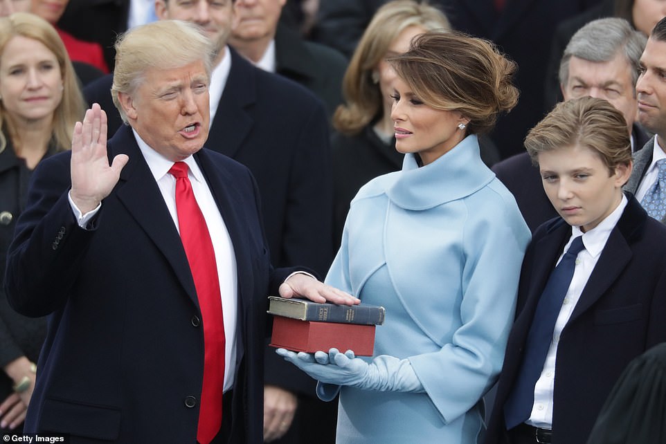 Melania holds the bible as her husband takes office on January 20, 2017