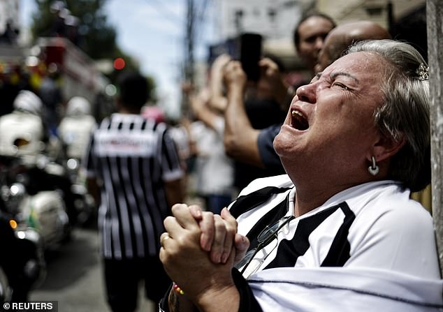 Where before there was peace, now there was barely controlled chaos as thousands of supporters crowded in front of the doors of Doña Celeste's house, waving flags, praying, crying and clapping and waiting for the fire truck carrying the coffin of Pele.