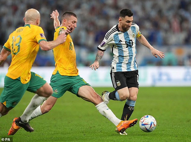 Australia's Mitchell Duke (left) and Argentina's Lionel Messi battle for the ball during the World Cup in Qatar