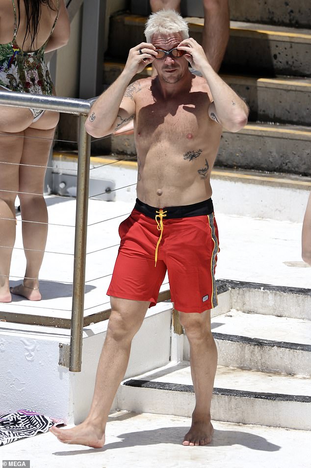 Diplo showed off his toned stomach and beefy pecs while soaking up some sun after New Year's events in Australia.  The star took a couple of laps around the pool