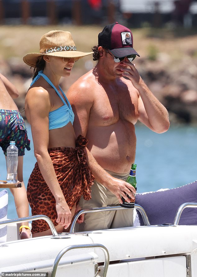 Michael wore a pair of gray shorts and a trucker hat as he stood on the deck of the ship.