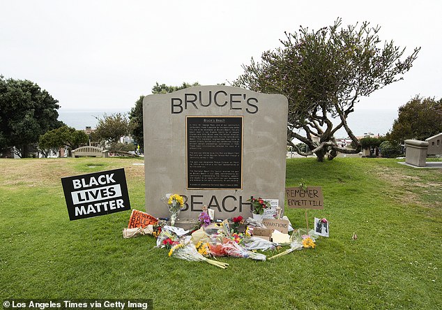 A Bruce's Beach plaque stands on property that used to be owned by Charles and Willa Bruce before it was seized by the government.