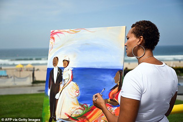 Artist Shelley Bruce paints a picture of the Bruce family during a ceremony transferring ownership of Bruce's Beach to the descendants of Willa and Charles Bruce.