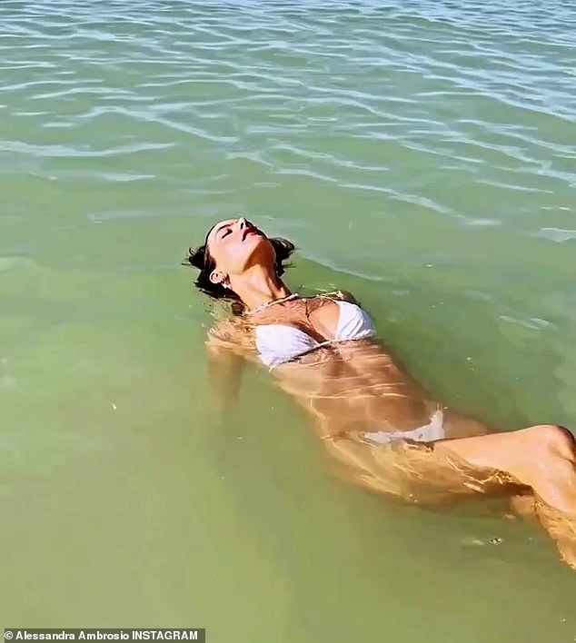 Just floating: The former Victoria's Secret model shared a photo of her toned tummy as she floated in the water