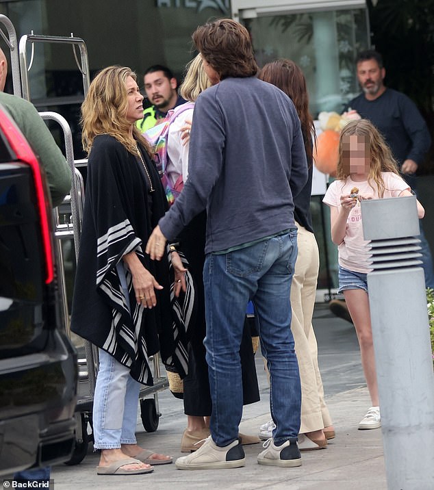 Talkative: Before taking off, Aniston spent some time chatting with her friends and their respective families.