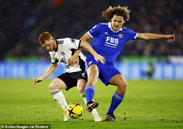 Tackle: Leicester's Wout Faes battles for the ball with Fulham's Harrison Reed (left)