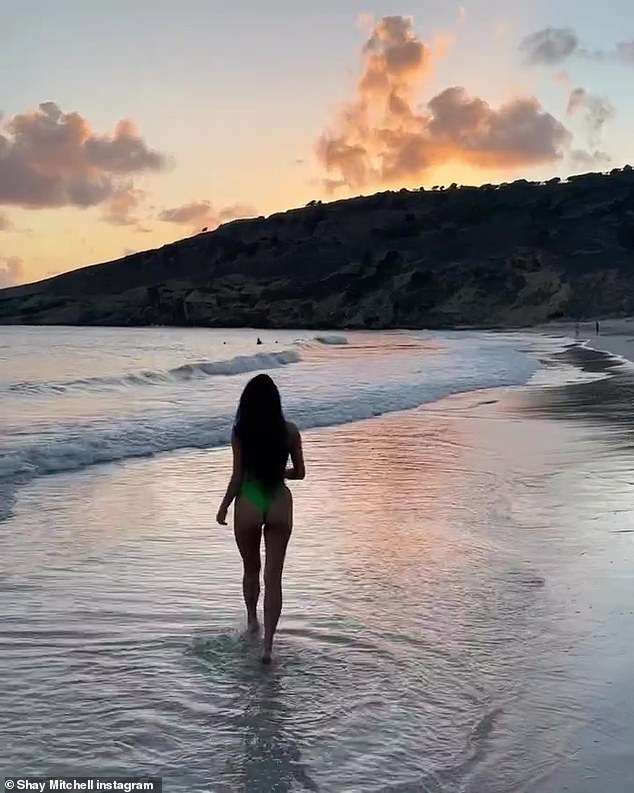 Paradise: She later cooled off in the ocean as the sun went down in another artistic social media snap.