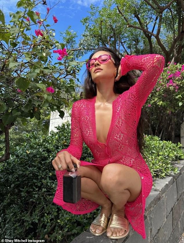 Chic: The You actress has been sharing a gallery of snaps from her luxury trip, including a pink knit midi dress she wore over a white bikini