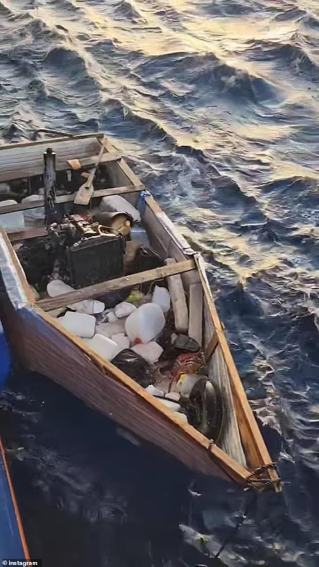 A wooden-constructed raft is tethered to the Celebrity Beyond cruise ship after 19 migrants were seen stranded at sea about 200 miles off the coast of Fort Lauderdale, Florida, on Monday.