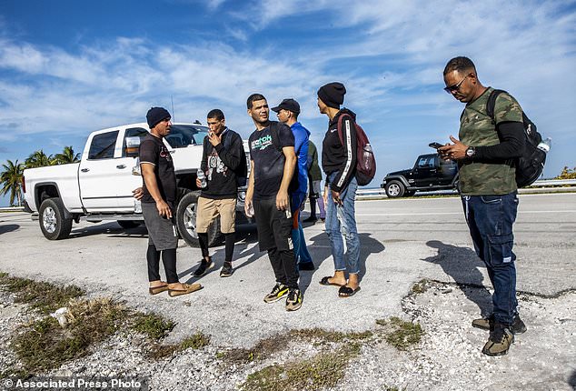 A group of Cuban immigrants stand in the sun on the side of US Highway 1 on the island of Duck Key, Florida, in the Middle Keys, on Monday.