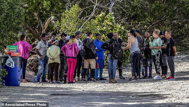 A group of Cuban immigrants stand in the sun on the side of US Highway 1 on the island of Duck Key, Florida, in the Middle Keys, on Monday.