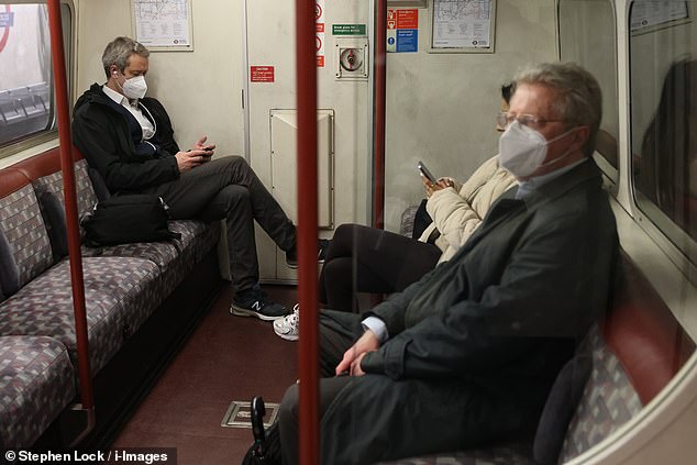 Pictured: People wearing face masks on the London Underground on January 4 after new advice has been given to curb rising infections as flu and Covid number increase