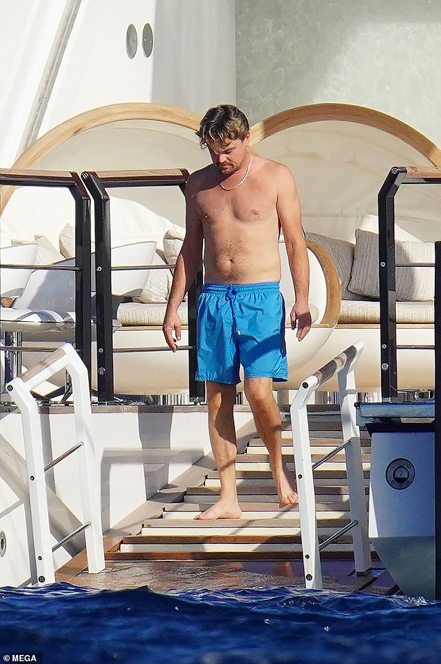 Topping up his tan: The group was seen on the yacht on Tuesday as Leonardo stripped down to reveal his shirtless torso