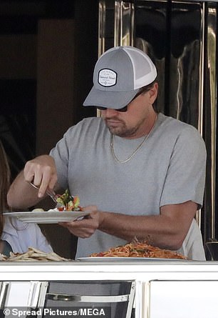 Lunch: Leonardo loaded his plate with food prepared by the chef on board.