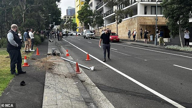 Locals are pictured at the scene of an accident on a central Sydney street on Wednesday