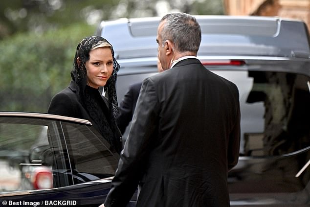 Charlene offered a brief smile as she left her car on her way to the event in Monaco this morning.