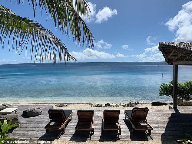 In the image, you can see an impressive deck facing crystal clear waters.