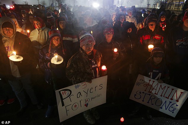 Buffalo Bills fans and community members gather for a candlelight vigil for the safety of the Bills