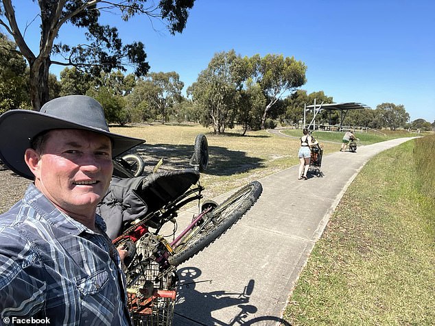 The group took the pile of clutter (pictured with Mr. Rushworth) to a dumpster in the park in hopes that the Wyndham City Council would haul it away.