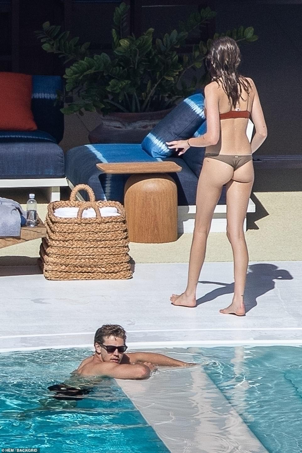 Cool!  As Butler relaxed in the water, Kaia sported his cheeky bikini top.