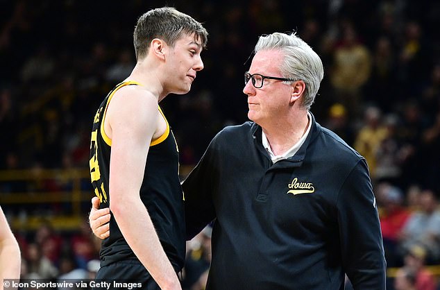 Iowa forward Patrick McCaffery (22) congratulates his father after his 500th victory as a coach after winning a college basketball game between the Iowa State Cyclones and the Iowa Hawkeyes on December 8.