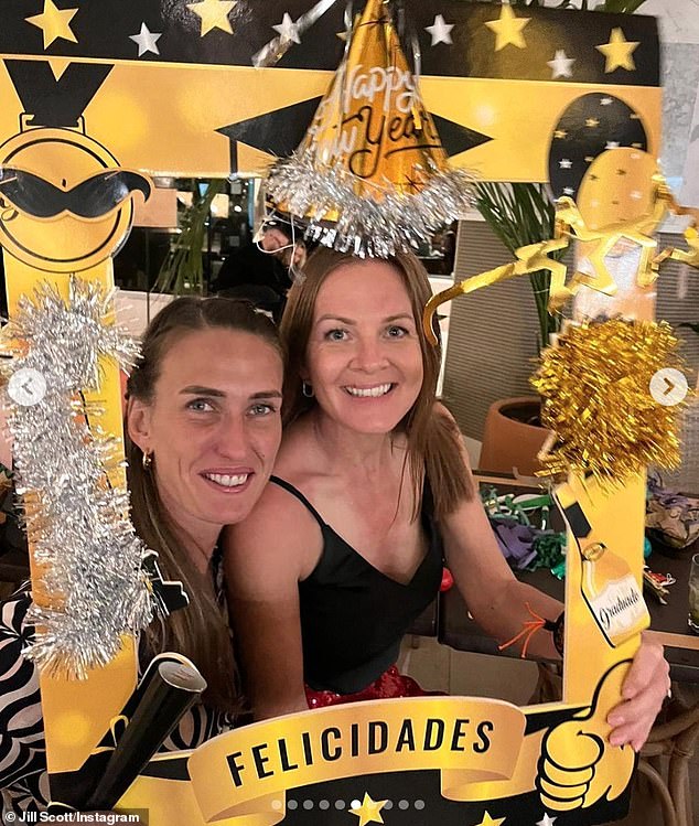 Glam: As the couple ringed in the New Year, they posed amongst a tinsel-covered cardboard photo frame and champagne bottles