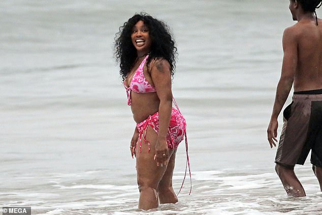 Dizzying: SZA smiled as she enjoyed a dip in the water with her handsome partner