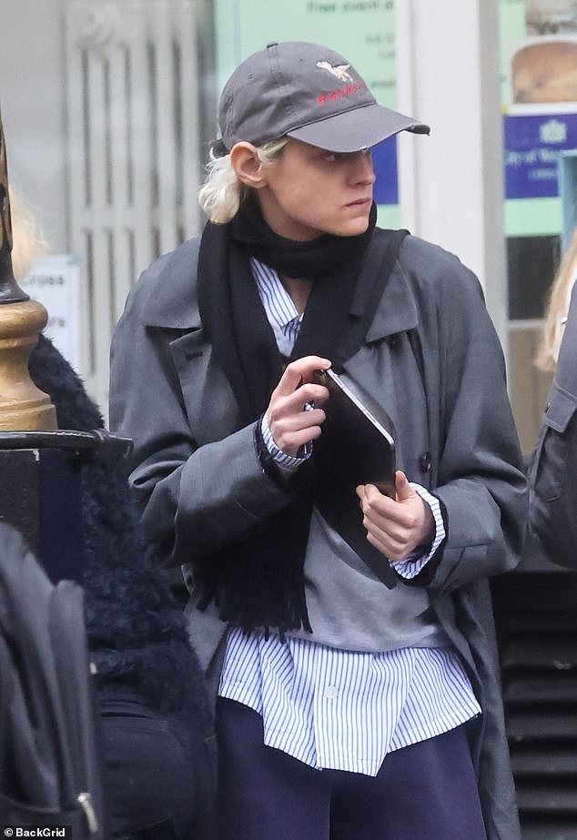 Out and about: The Crown star cut a casual figure in a pale blue striped shirt and navy sweatpants as they headed to the theater for their latest performance