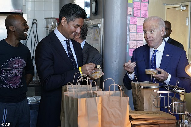 President Joe Biden and Cincinnati Mayor Aftab Puerval eat some of their orders while visiting the Just Q'in BBQ in Cincinnati, Wednesday, Jan. 4, 2023. Biden commented on the border while traveling to see the Brent Spence Bridge with the Senate.  Minority Leader Mitch McConnell