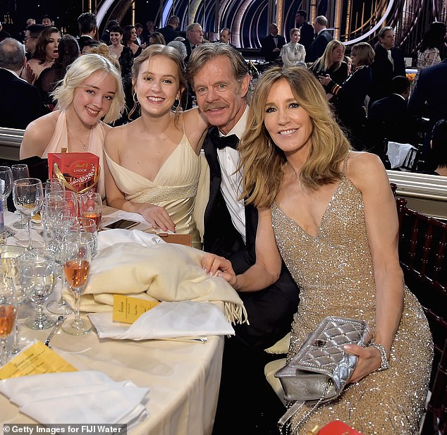 Among the parents who used Singer's services was Felicity Huffman, pictured above with her husband and two daughters.  She served 14 days in prison.