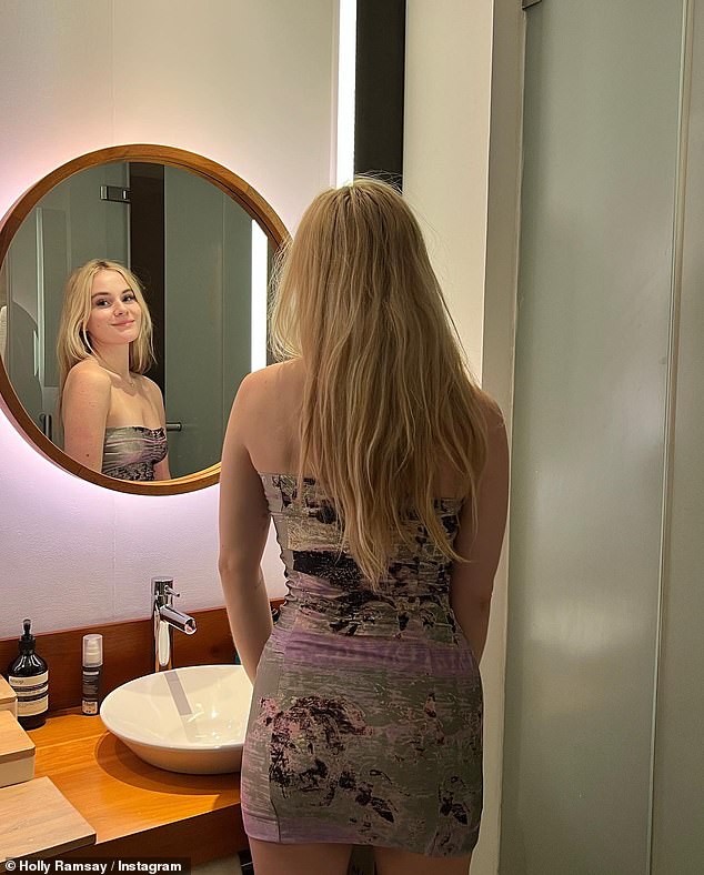 Gorgeous: Holly dressed in a glamorous silver and lilac bandeau dress that she modeled in the mirror