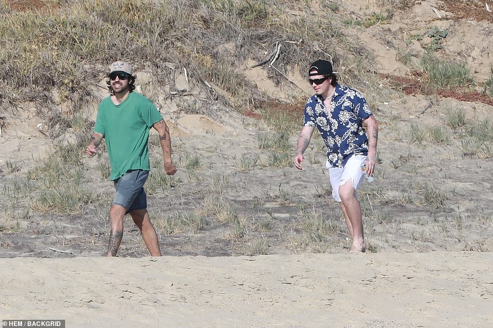 Taking a walk: The former model was seen taking a walk in the sand with a friend