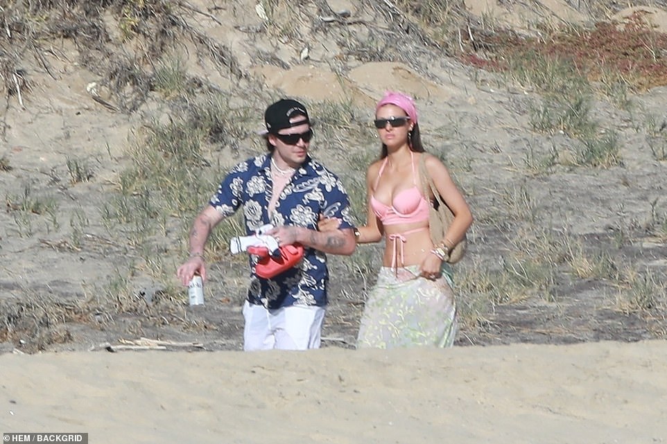 Laid back: Aspiring chef Brooklyn rocked a loose button-down blue and white Hawaiian shirt with white Nike shorts