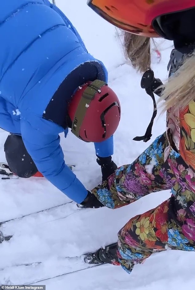 What a gentleman: Heidi showed off her husband's chivalry at one point, filming Tom as he helped lace up his skis