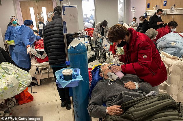 Pictured: A woman helps a patient at Tongren hospital in Shanghai on January 3, 2023. In a rare rebuke to Beijing, the WHO said China was using a definition 