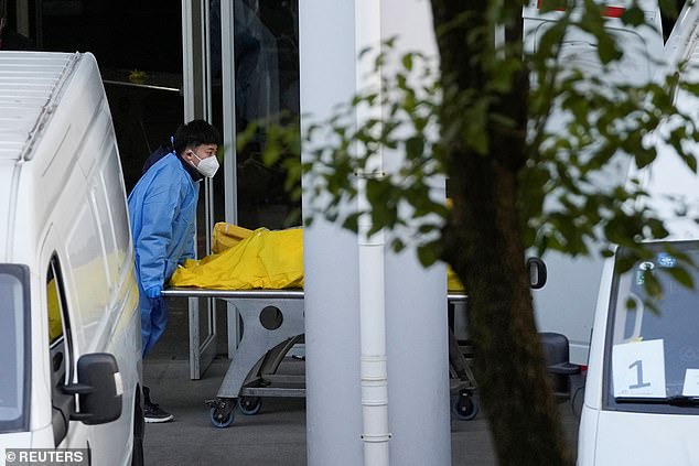 A staff member pushes a cart carrying a body bag at a funeral home as Covid-19 outbreaks continue in Shanghai, China, on January 4.