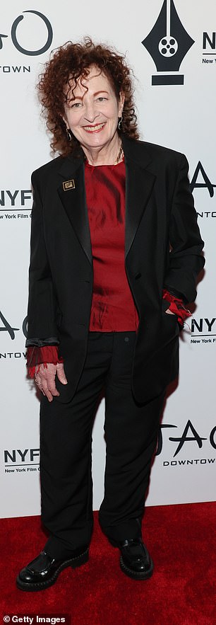 Burst of red: American photographer Nan Goldin, 69, wore a red blouse under a black suit