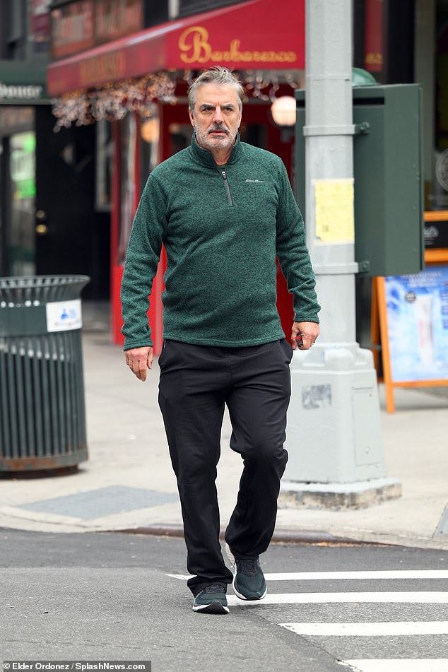 The actor was seen walking around, wearing a long-sleeved green wool zip-up sweater, black pants, and black and green sneakers as he crossed the street.