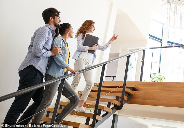 Some argued that the property manager should have considered the damage as normal wear and tear (file image of real estate agent with tenants)