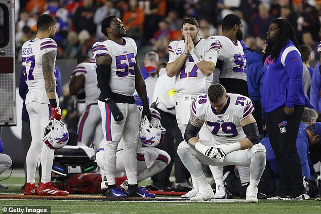 Both the Bills (above) and Bengals players were visibly upset when Hamlin received CPR on the field.