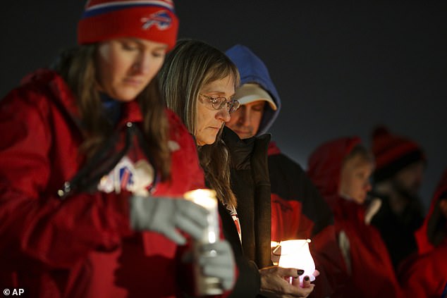 Buffalo Bills fans and community members gather for a candlelight vigil for the safety of Buffalo Bills Hamlin in Orchard Park, New York