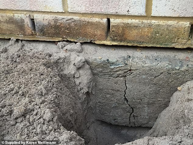 The house, which is located on the Ocean Lagoon Estate, is sinking into the ground (pictured) as it was built on karst rocks.  Loose soil dissolves from groundwater causing the house and retaining wall to collapse (pictured)