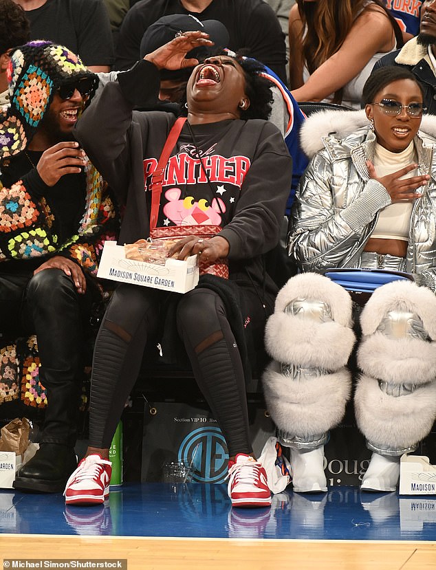 Laughing Leslie: She donned a red handbag, accessorized with small silver hoop earrings, and finished her look with red and white Nike Low Dunks sneakers.