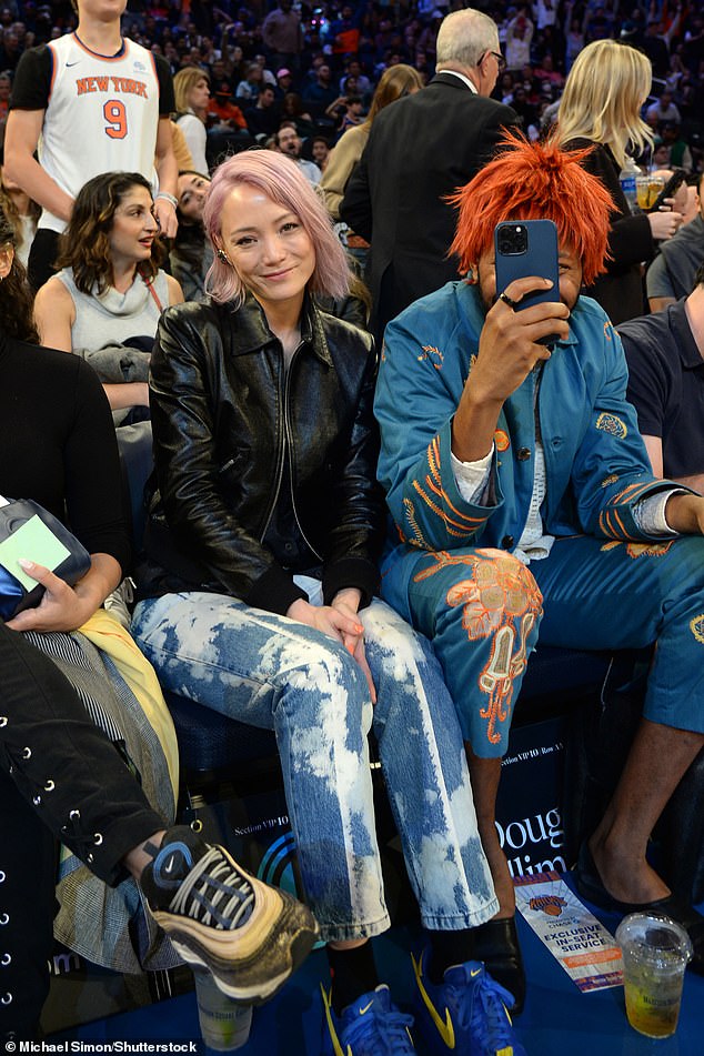 Smiles: Pom Klementieff smiles for a photographer as Jeremy O. Harris shields his face with his phone