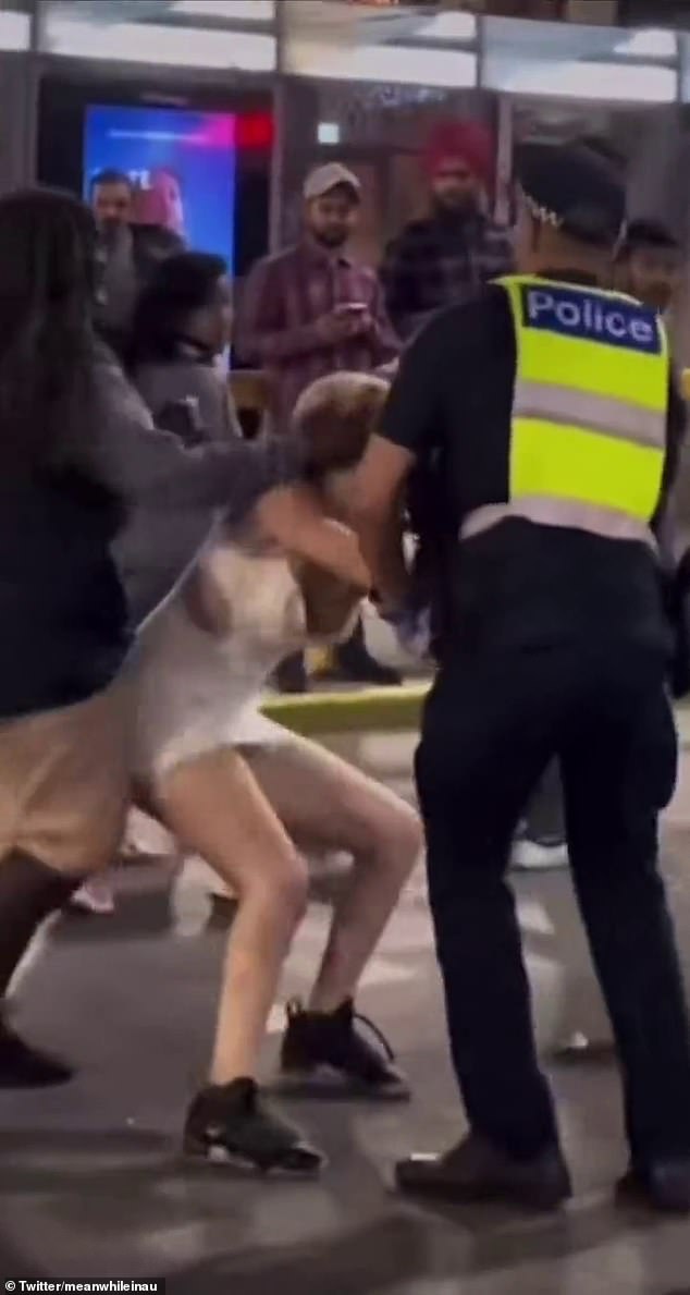 Another woman tried to intervene while the blonde woman punched and kicked the officers.